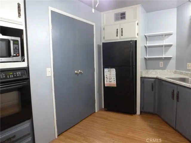 a kitchen with a refrigerator and a stove