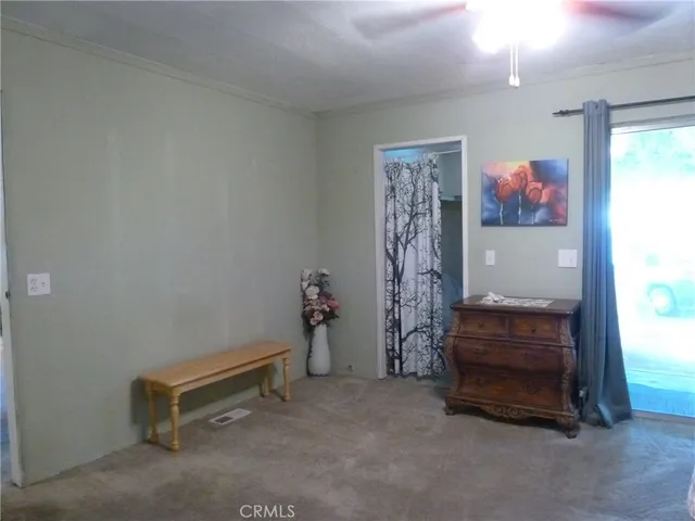 a room with furniture and a ceiling fan