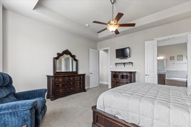 a spacious bedroom with a bed and a couch