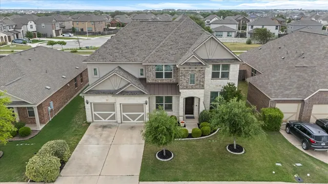 an aerial view of a house with yard