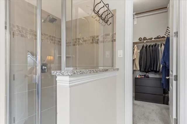 a kitchen with a refrigerator and a stove top oven