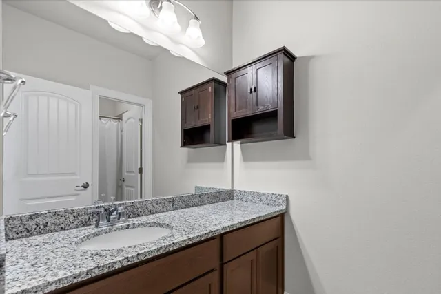 a bathroom with a sink double vanity and a mirror