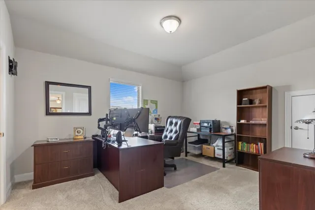 a view of a patio with table and chairs under an umbrella