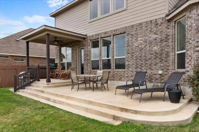 a front view of a house with swimming pool having outdoor seating