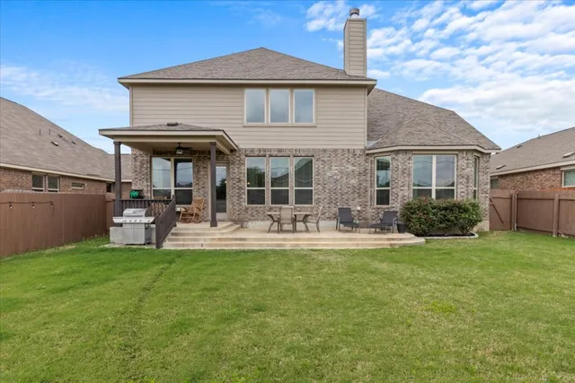 a view of a house with backyard porch and sitting area
