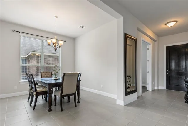 a view of a dining room with a table and chairs