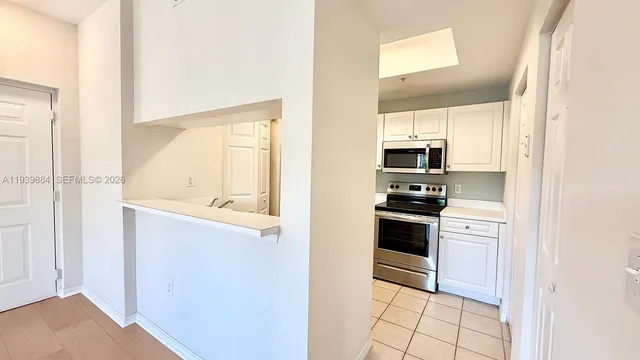 a kitchen with a refrigerator stove and microwave