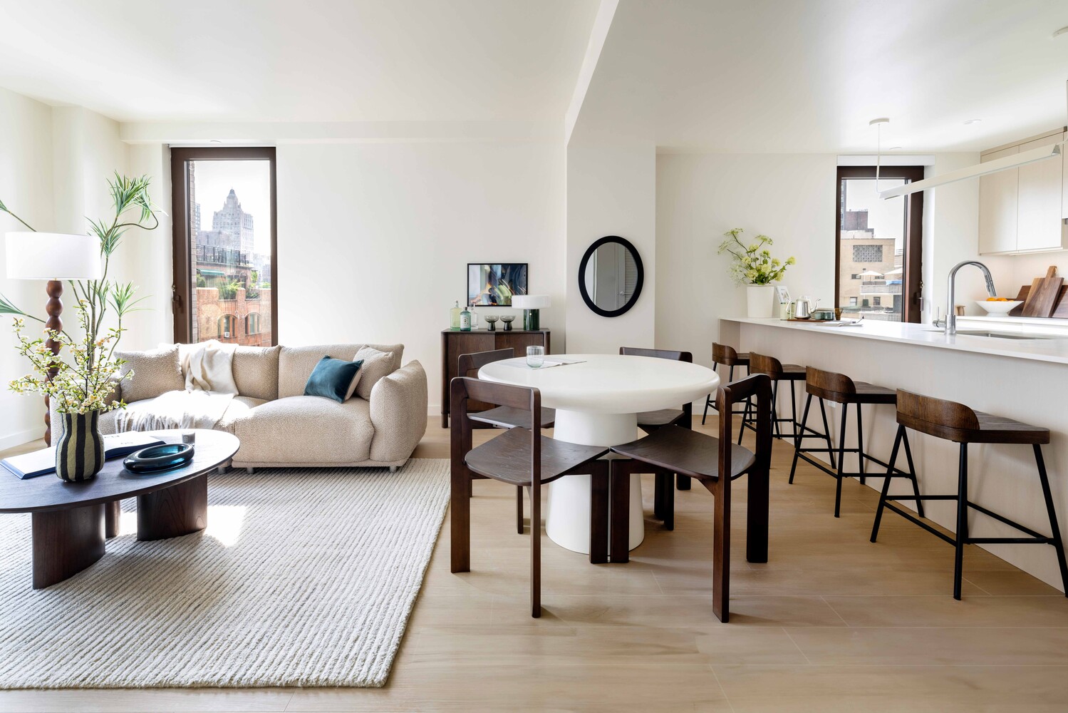 300 East 50th Street, Unit 22B Manhattan, NY 10022 - Photo 1 of 22 a living room with furniture a clock on wall and a window
