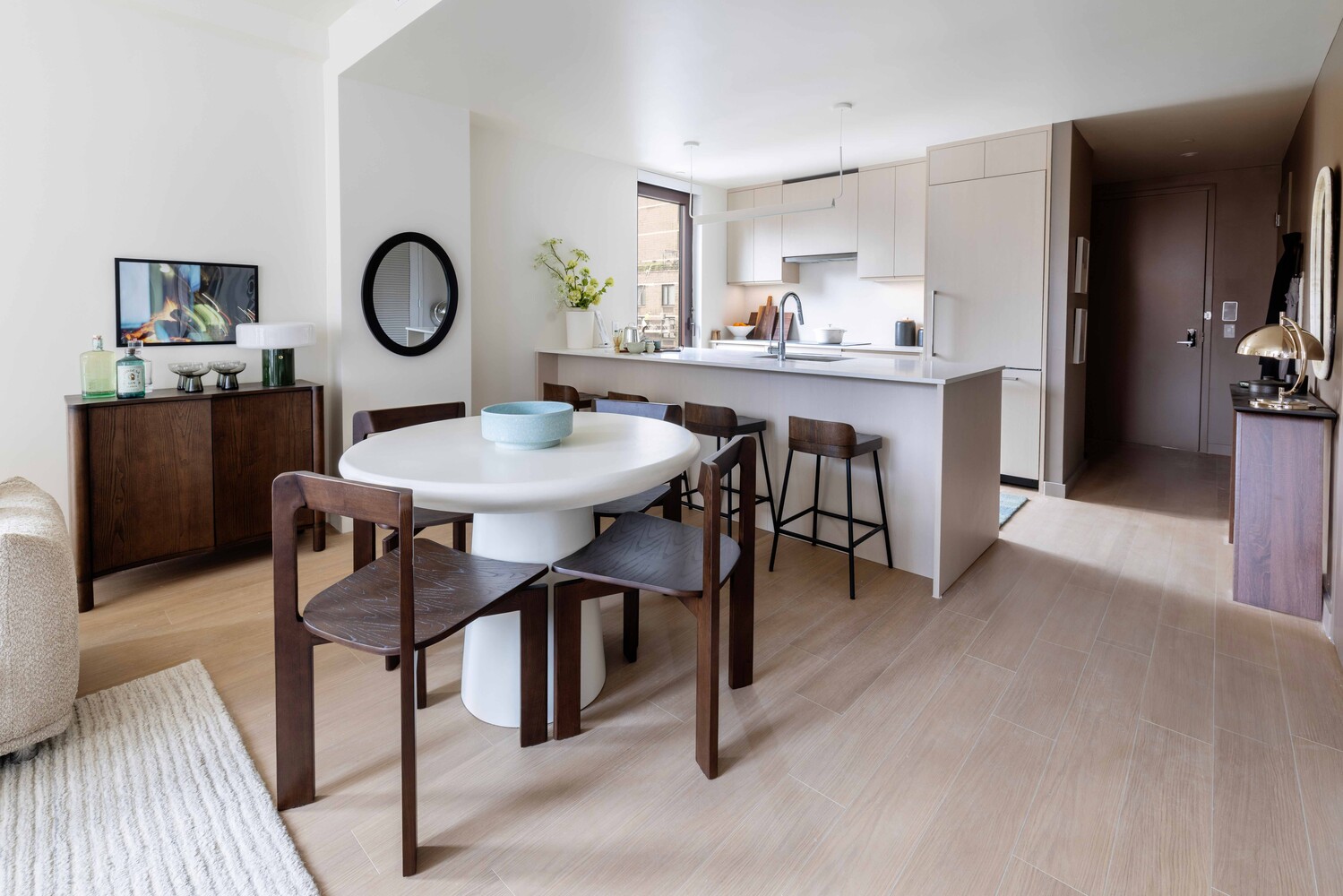 300 East 50th Street, Unit 22B Manhattan, NY 10022 - Photo 4 of 22 a view of a dining room and a kitchen with a table chairs
