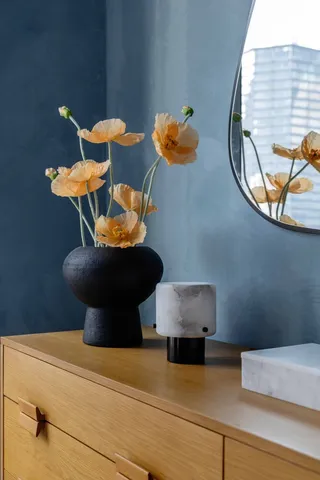 a room with painting on the wall and a window