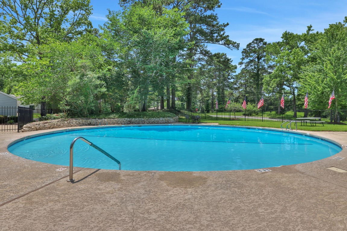 207 Green Tree Drive Coldspring, TX 77331 - Photo 10 of 20 a view of a tennis ground with large trees