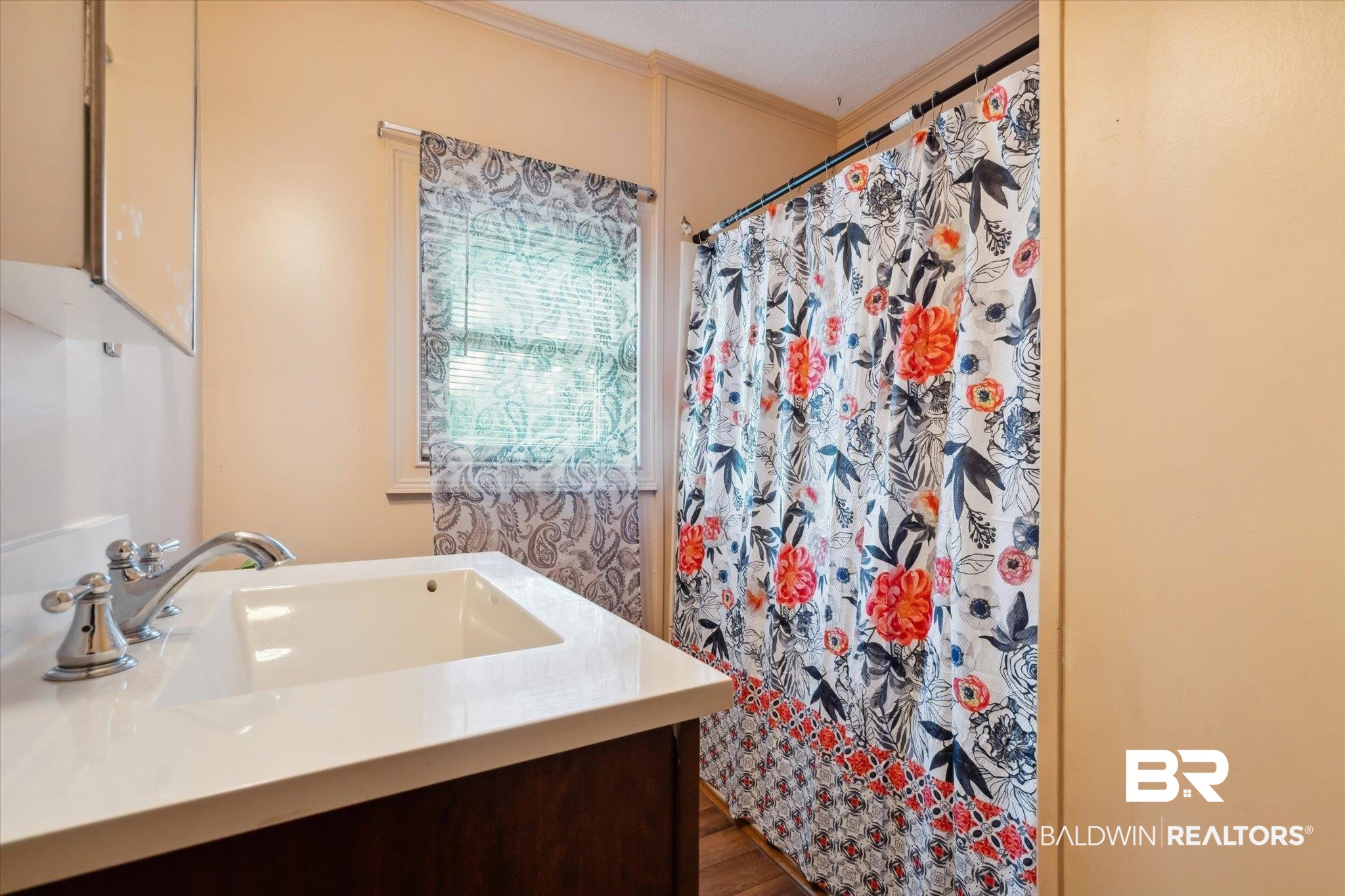 4851 Lesure Road Theodore, AL 36582 - Photo 13 of 21 Bathroom featuring hardwood / wood-style flooring, vanity, and ornamental molding