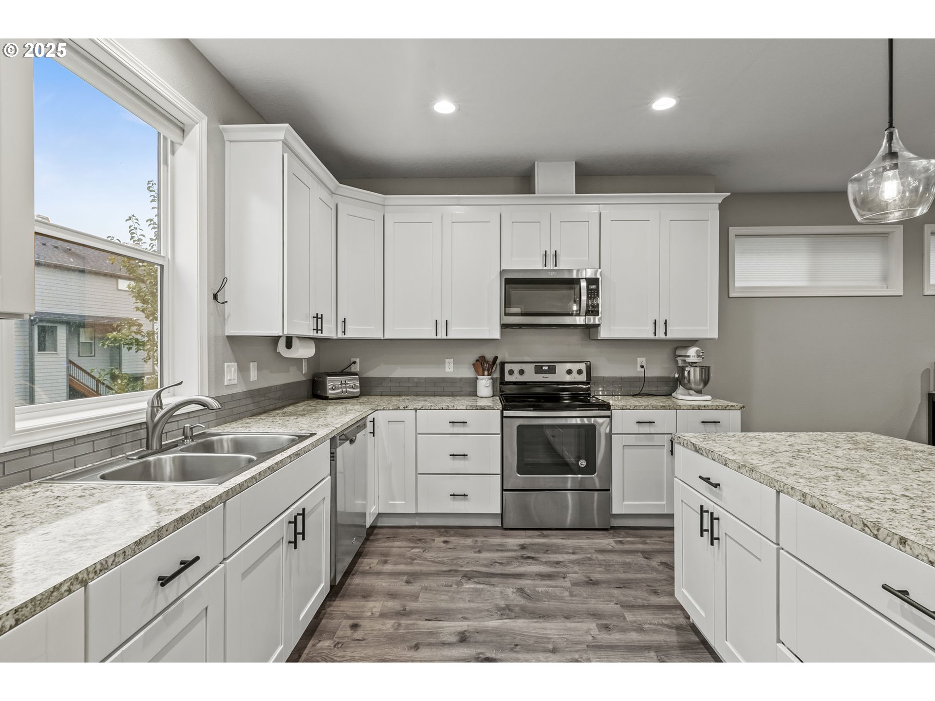 1783 Lewis River Road Woodland, WA 98674 - Photo 12 of 32 a kitchen with kitchen island granite countertop white cabinets white stainless steel appliances with a sink and dishwasher
