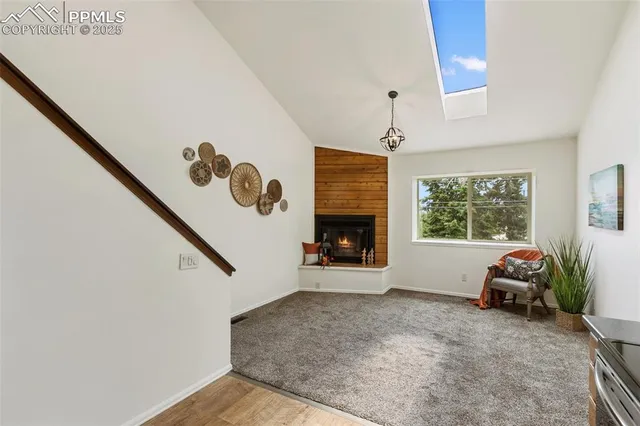 a view of a livingroom with a fireplace and window