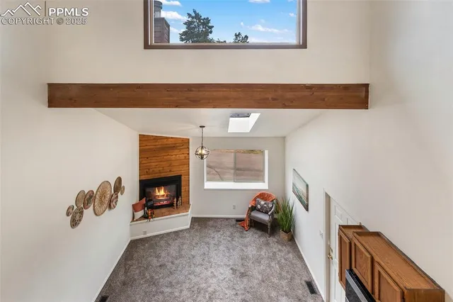 a view of living room with furniture and a fireplace