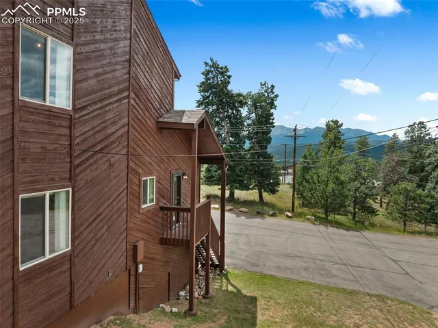 an aerial view of a house with outdoor seating