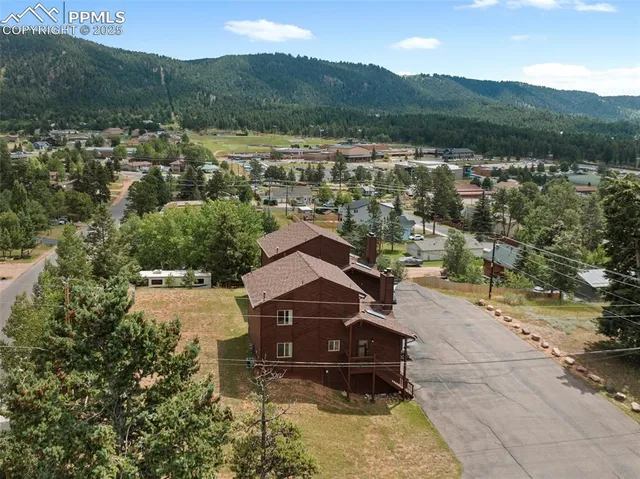 a view of a wooden house with a big yard