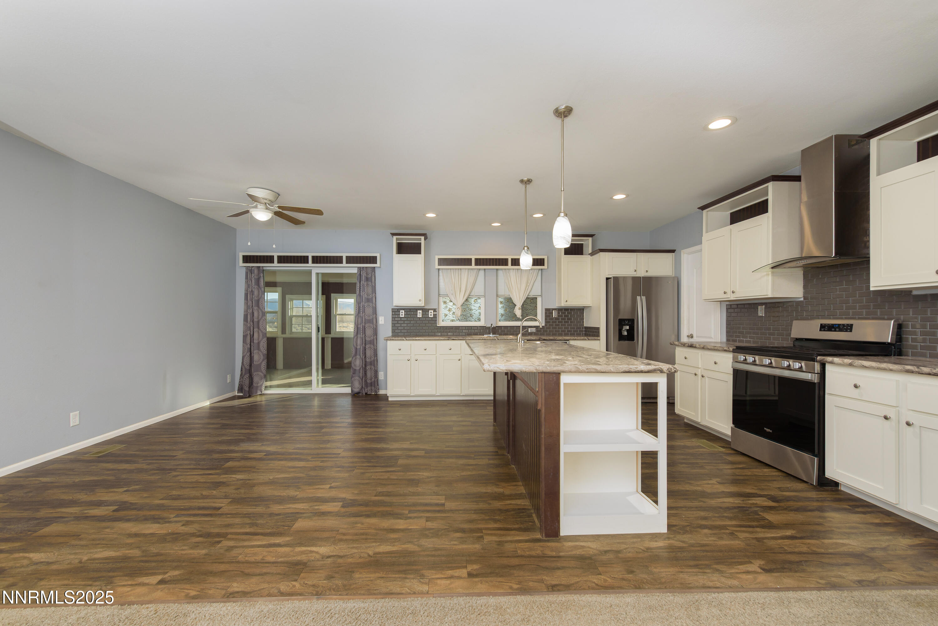 2595 4th Street Silver Springs, NV 89429 - Photo 12 of 54 a large kitchen with kitchen island a sink stainless steel appliances and cabinets