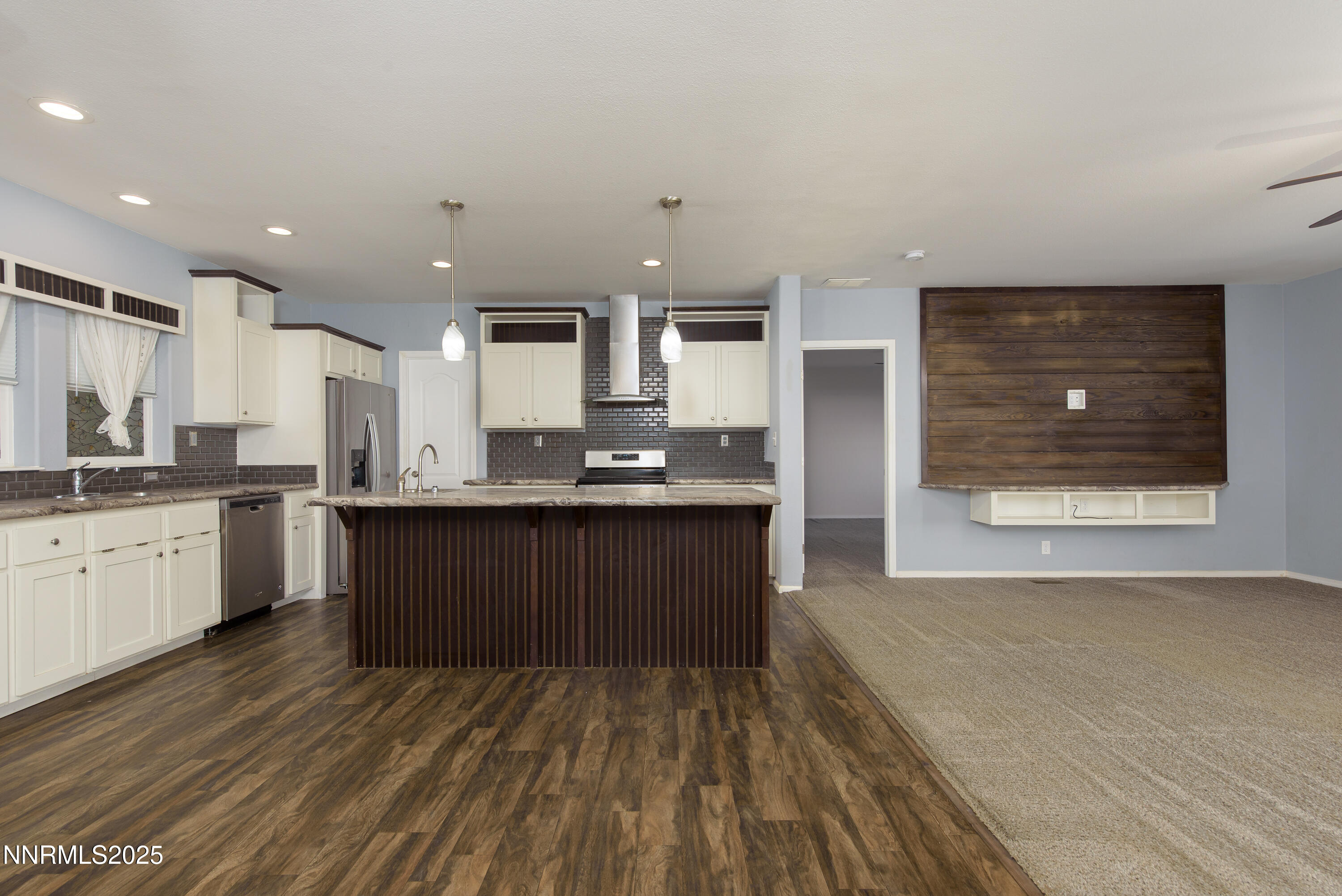 2595 4th Street Silver Springs, NV 89429 - Photo 13 of 54 a large kitchen with kitchen island a sink dishwasher a stove and a refrigerator with wooden floor