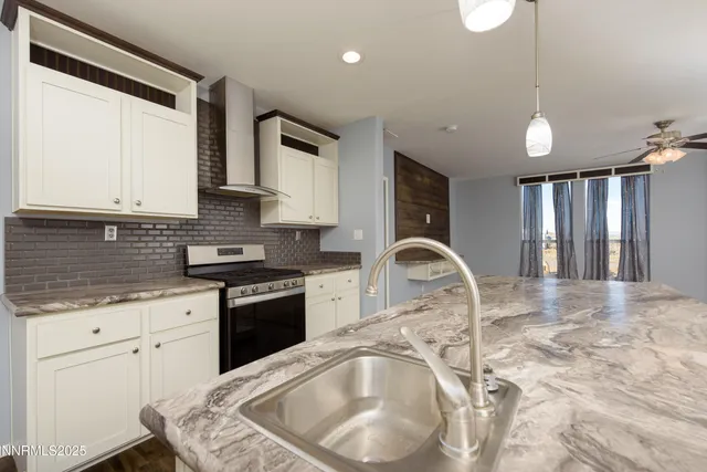a kitchen with stainless steel appliances granite countertop a stove a refrigerator and a sink