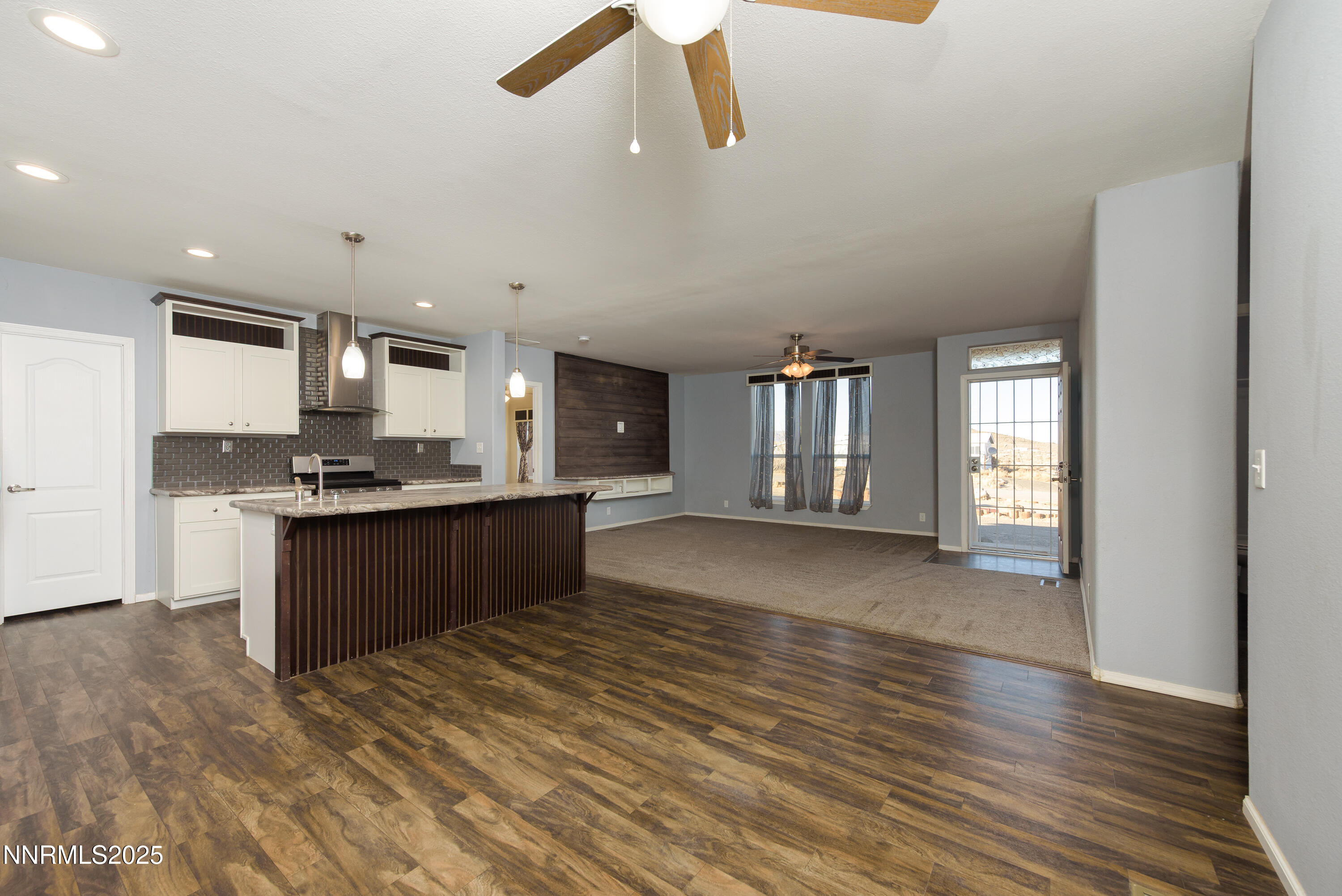 2595 4th Street Silver Springs, NV 89429 - Photo 18 of 54 a kitchen with stainless steel appliances kitchen island granite countertop a stove a sink and a refrigerator