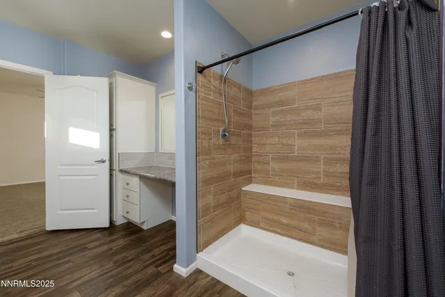 a view of a livingroom with a ceiling fan and window