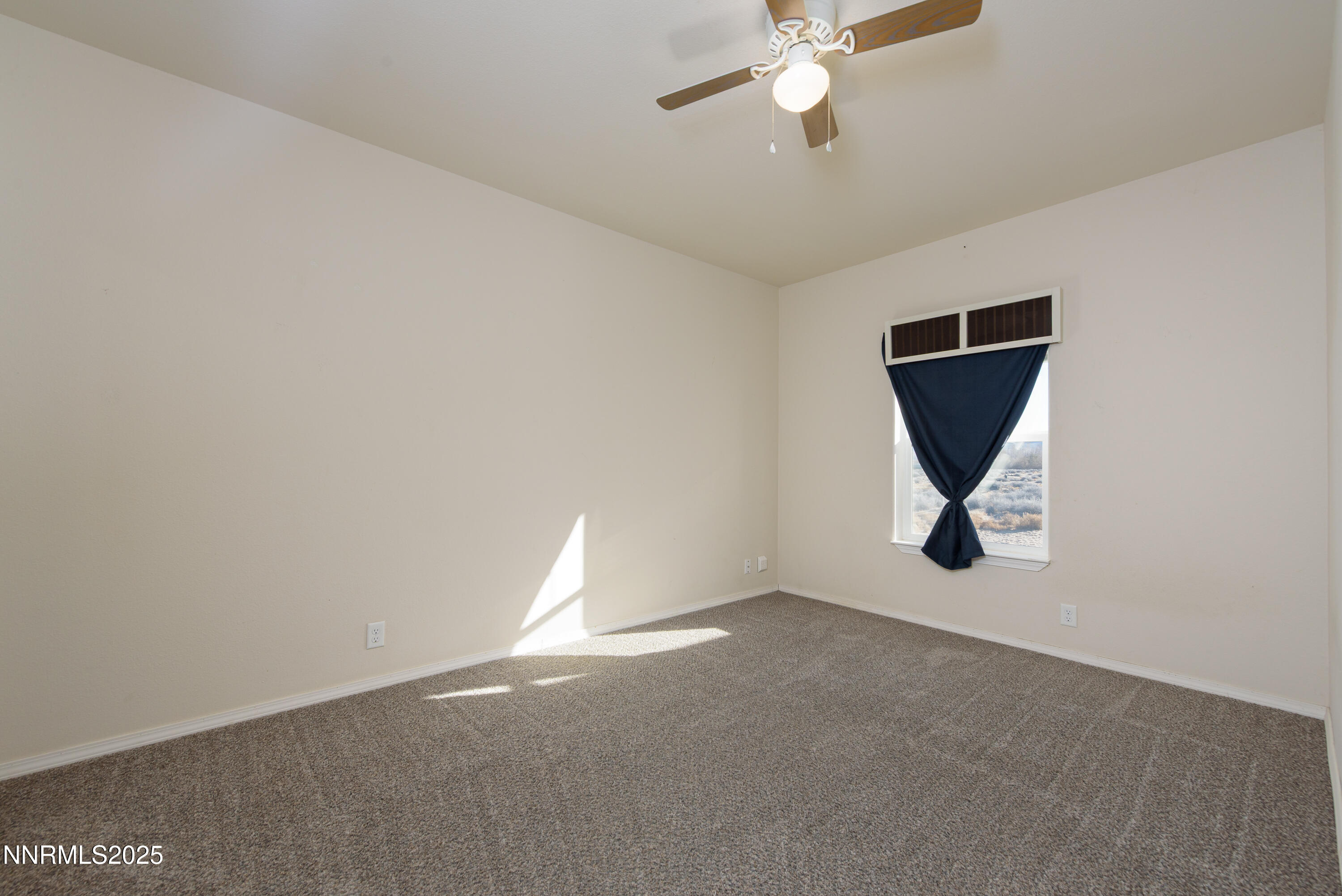 2595 4th Street Silver Springs, NV 89429 - Photo 28 of 54 a view of a livingroom with a ceiling fan and window