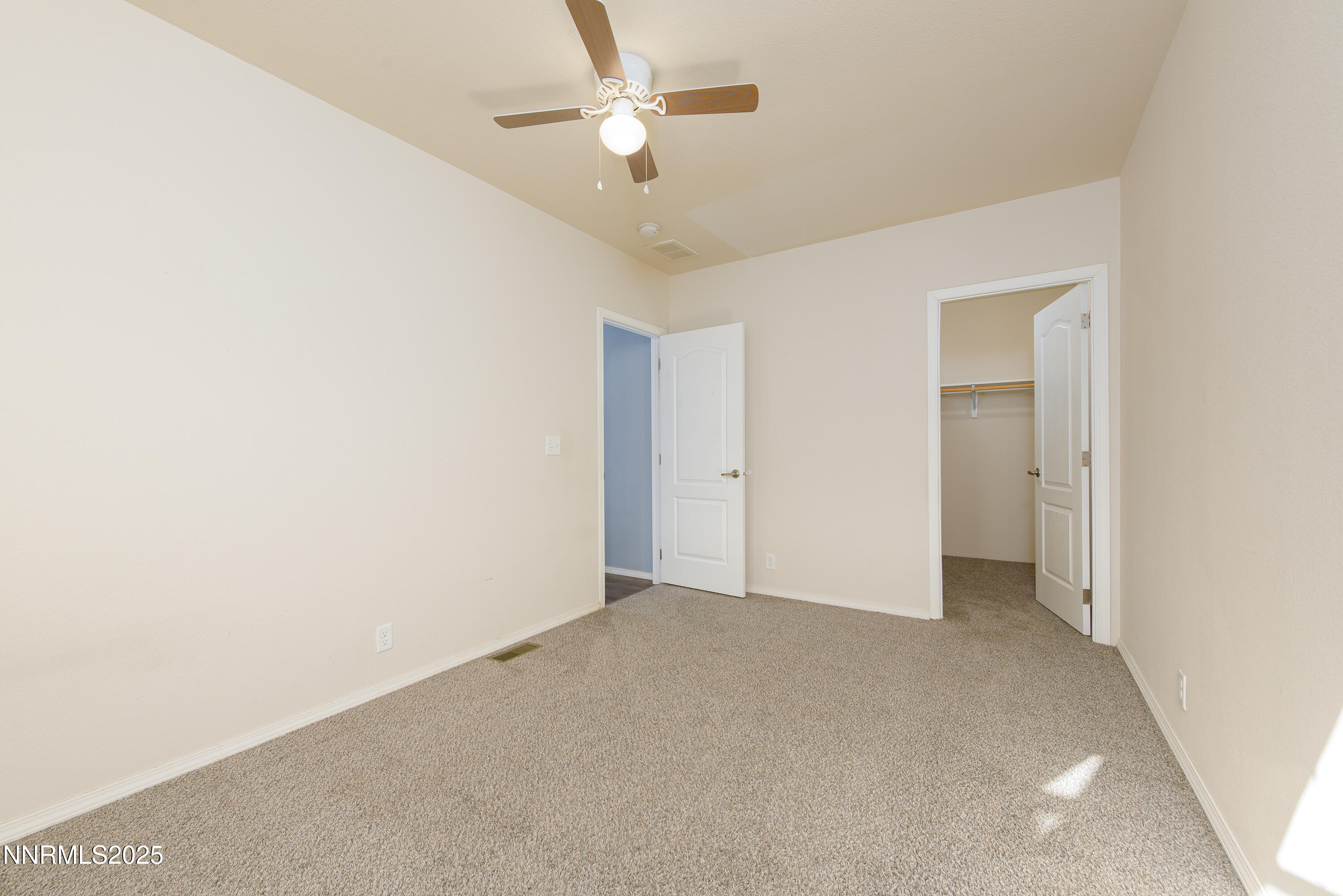 2595 4th Street Silver Springs, NV 89429 - Photo 29 of 54 an empty room with a ceiling fan and a window