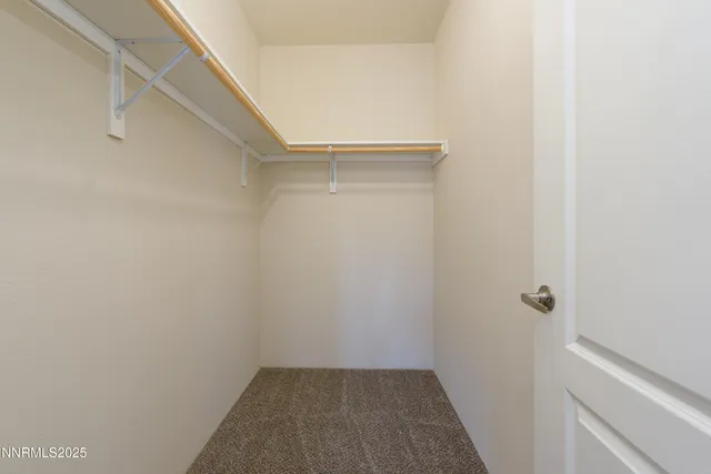 a view of a hallway with wooden floor and closet