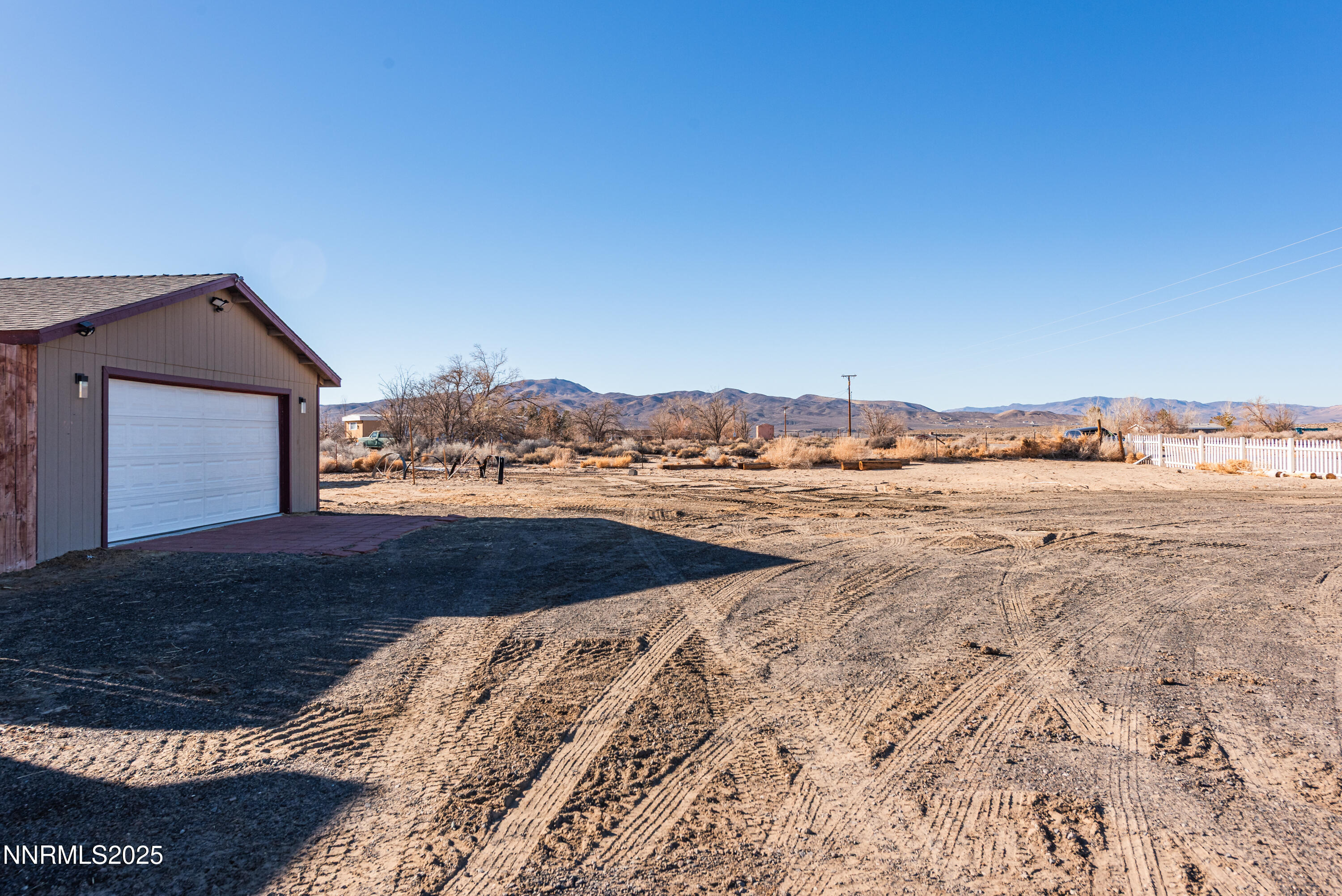 2595 4th Street Silver Springs, NV 89429 - Photo 42 of 54 a view of a dry yard with wooden fence