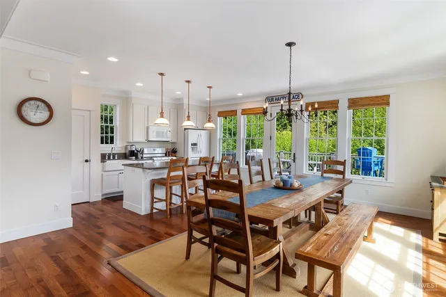 a dining room with furniture a chandelier and a rug