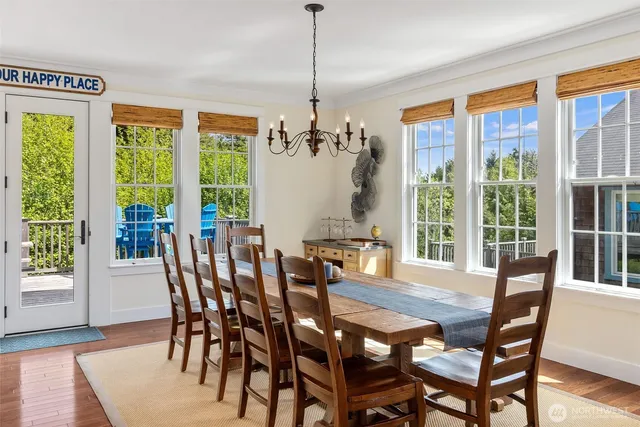 a view of a dining room with furniture large windows and wooden floor