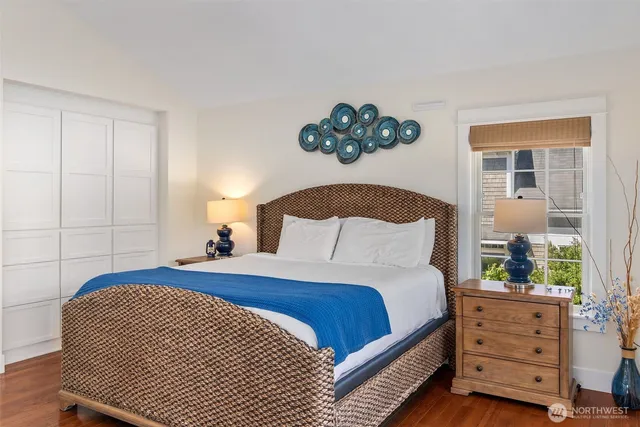 a bedroom with a bed and a painting on the wall