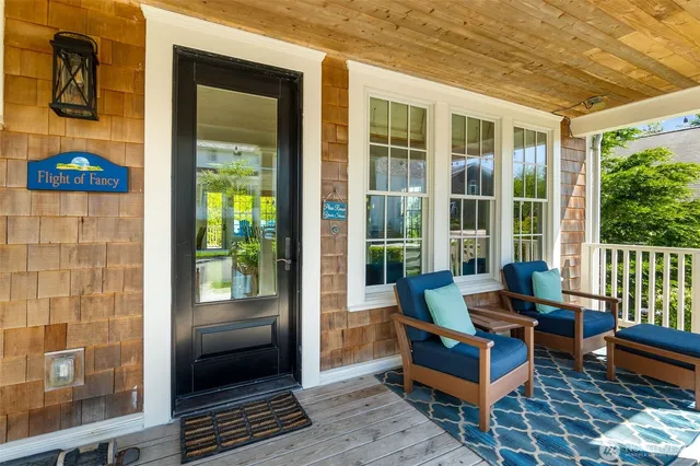 a building outdoor space with patio furniture and wooden floor