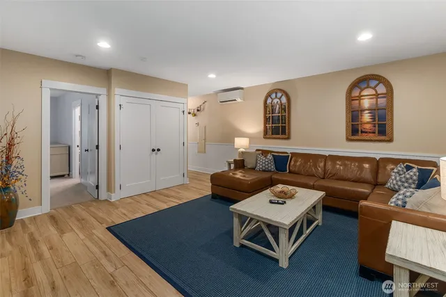 a living room with furniture and a wooden floor