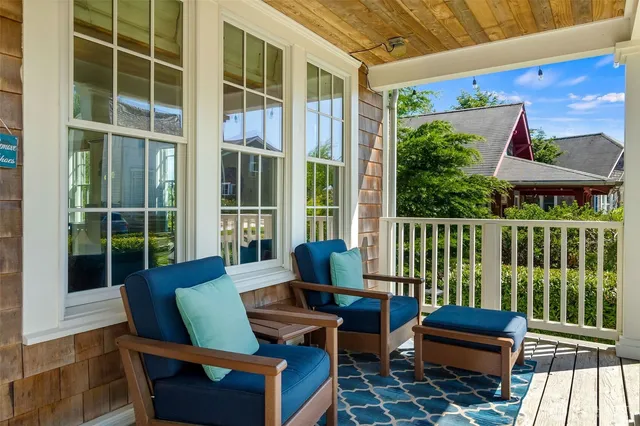 a balcony with furniture and wooden floor