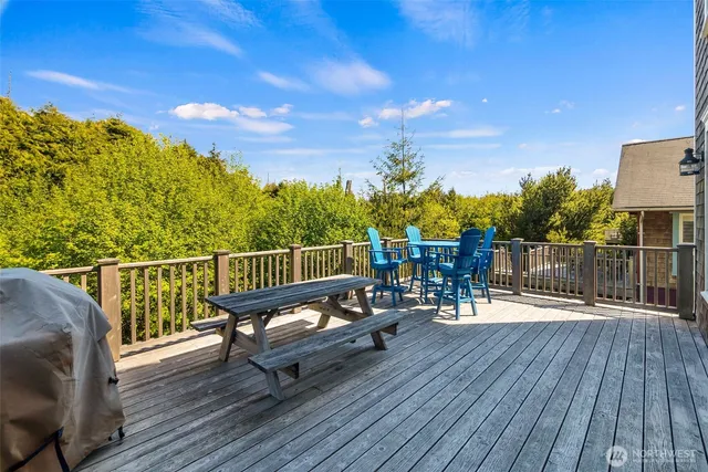 a view of a balcony with wooden floor and outdoor seating