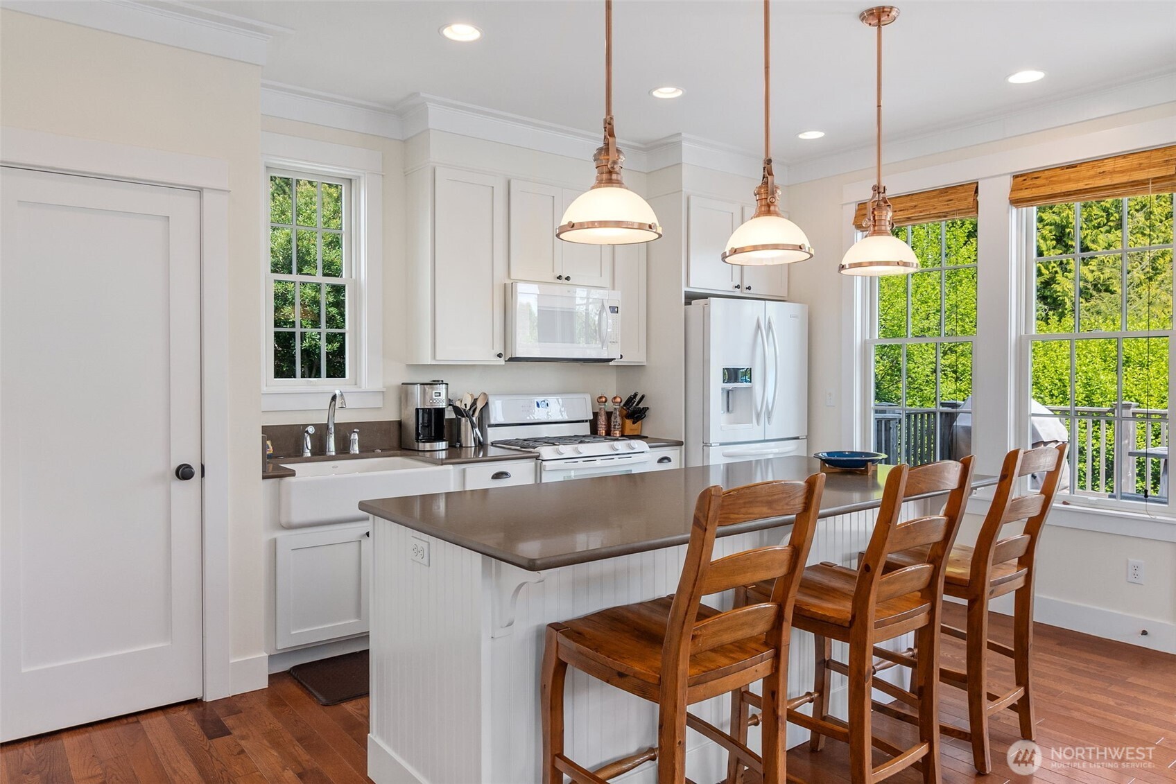 81 Compass Street Pacific Beach, WA 98571 - Photo 9 of 40 a kitchen with a table chairs and white cabinets