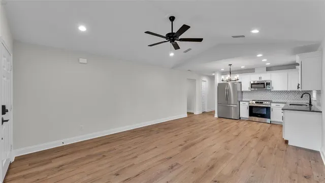 a view of a kitchen with a sink and wooden floor