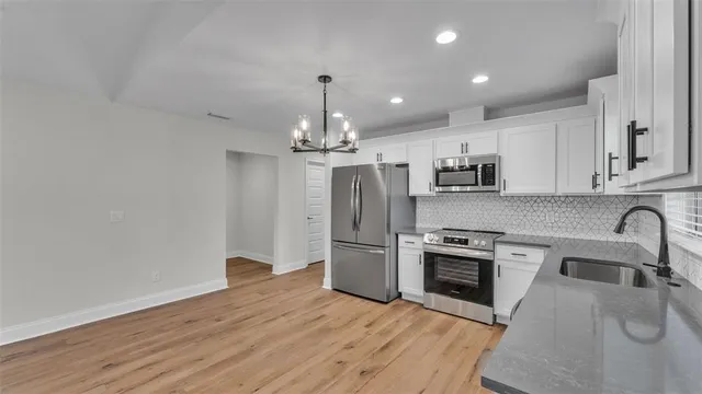 a kitchen with a sink stainless steel appliances and cabinets