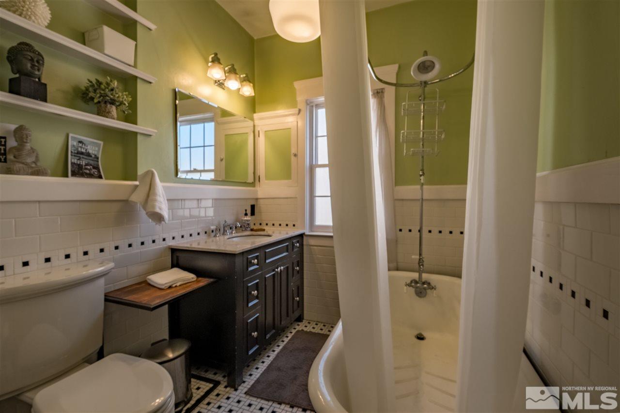 588 Marsh Avenue Reno, NV 89509 - Photo 7 of 28 a bathroom with a granite countertop toilet sink and mirror