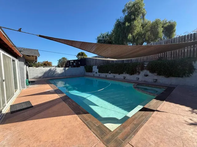 a view of a backyard with plants and a patio