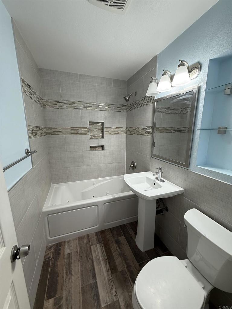 8859 Kelburn Avenue Spring Valley, CA 91977 - Photo 15 of 15 a bathroom with a sink toilet and shower