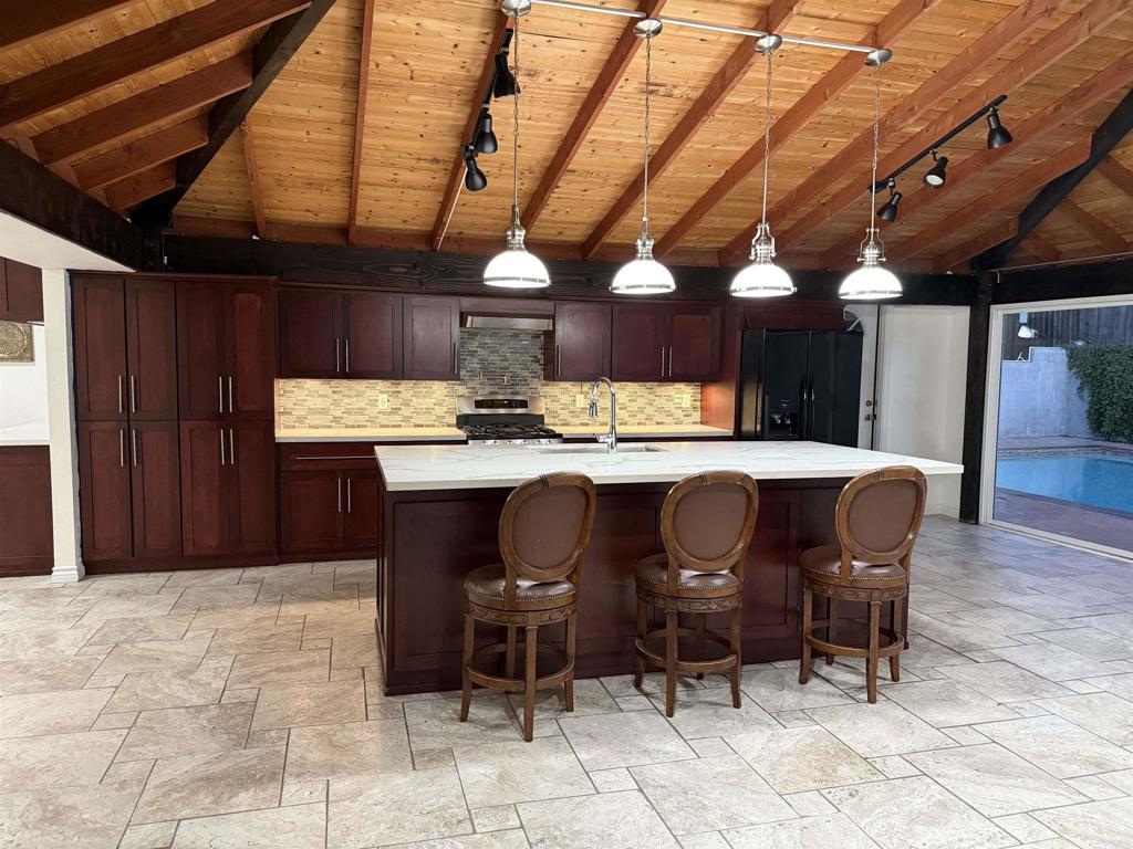 8859 Kelburn Avenue Spring Valley, CA 91977 - Photo 4 of 15 a view of a dining room with furniture and wooden floor