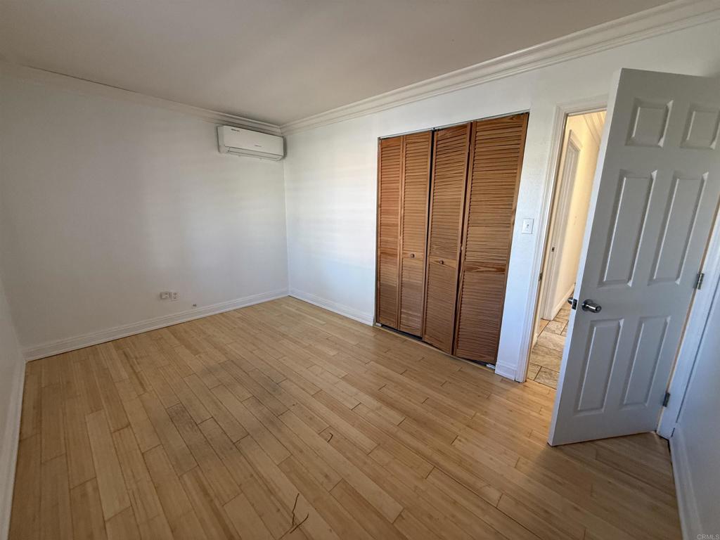 8859 Kelburn Avenue Spring Valley, CA 91977 - Photo 9 of 15 a view of an empty room with wooden floor and a window