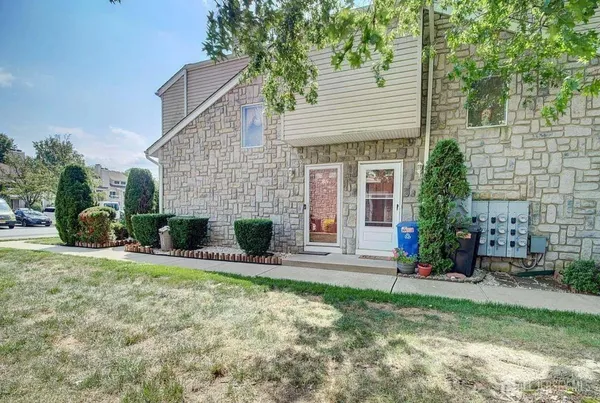 a view of a house with a yard and sitting area