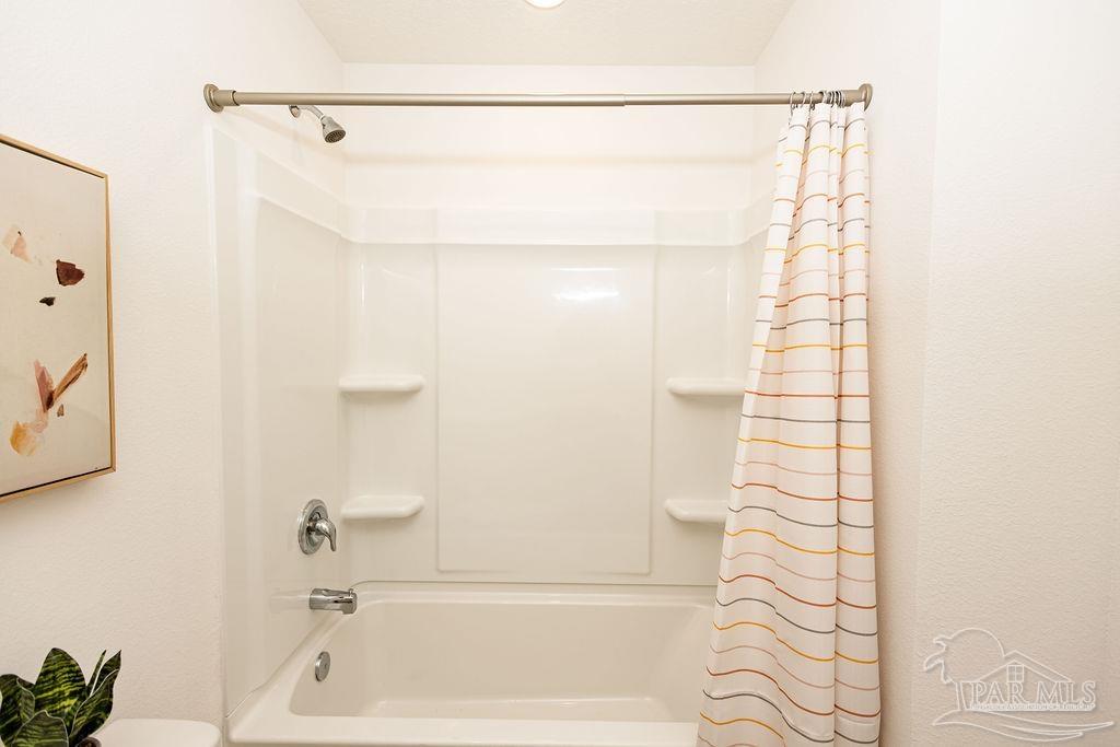 7761 Moonrise Way Milton, FL 32583 - Photo 15 of 19 a bathroom with a shower and a bath tub