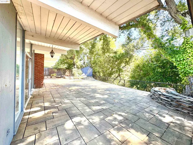 a view of backyard with a patio
