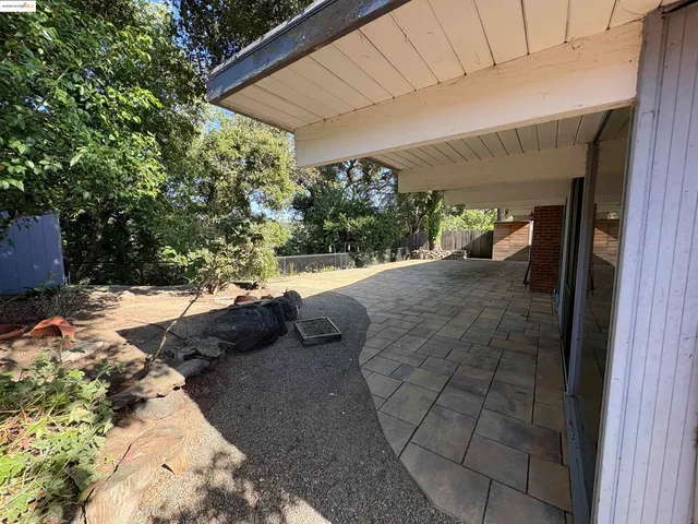 a view of a backyard with chairs
