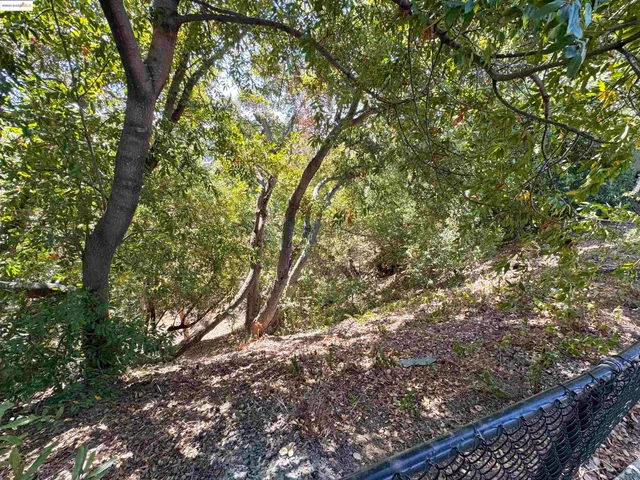 a view of wooden fence and a yard